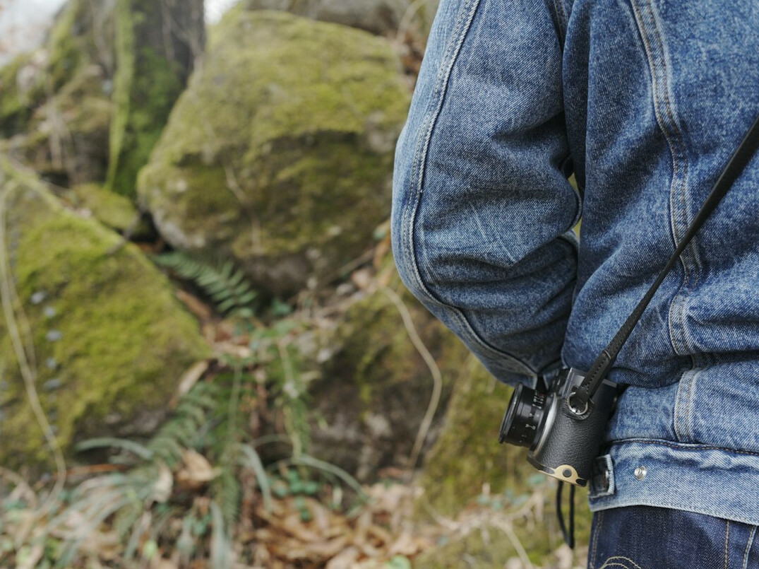 Field reporter holding a microphone outdoors